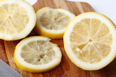 stack of citrus fruits slices. lemons. On wooden plateの写真素材