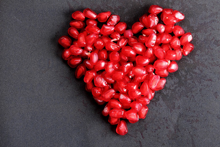 heart shape of pomegranate seedsの写真素材