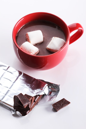 hot chocoalte drink with marshmallows and chocolate pieces on white backgroundの写真素材