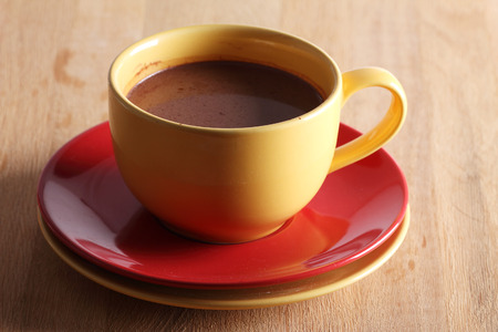 hot chocolate drink in colorful cups on wooden backgroundの写真素材