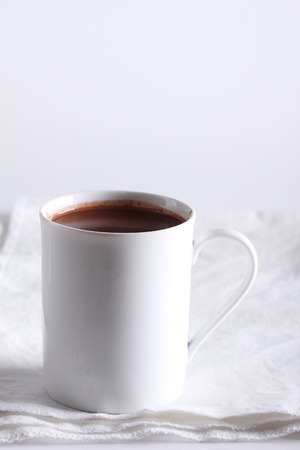 hot chocolate drink in white mug on white fabricの写真素材