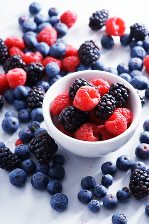 blueberries, raspberries and black berries. fresh berries on white backgroundの写真素材