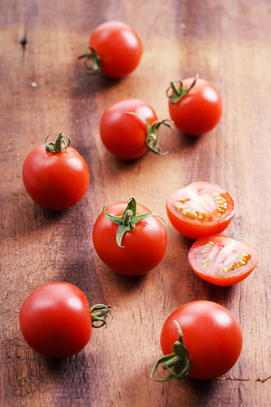Tomatoes. red ripe tomatoes on  wooden background.の写真素材