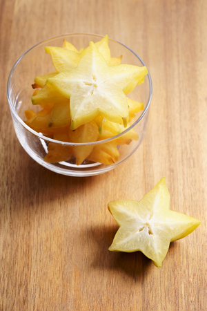 Star fruit, starfruit, carambola on wooden backgroundの写真素材