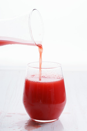 Healthy watermelon drink pouring into a glassの写真素材