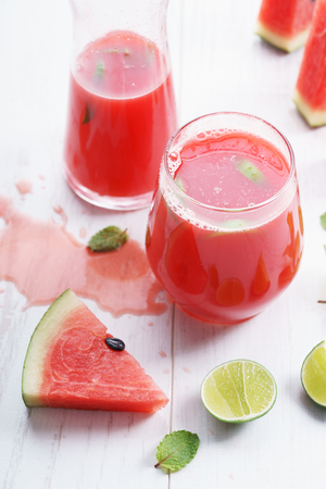 Healthy watermelon drink and fresh watermelon on white backgroundの写真素材