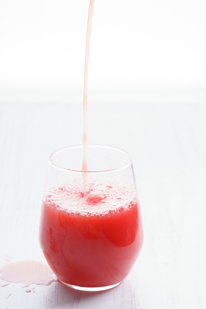 Healthy watermelon drink pouring into a glassの写真素材