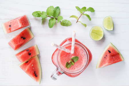 Healthy watermelon drink and fresh watermelon on white backgroundの写真素材