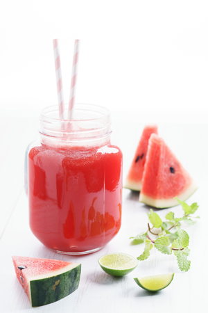 Healthy watermelon drink and fresh watermelon on white backgroundの写真素材