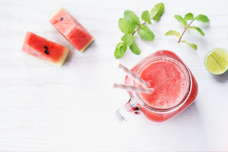 Healthy watermelon drink and fresh watermelon on white backgroundの写真素材