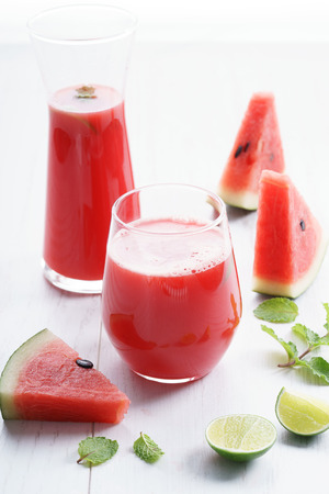 Healthy watermelon drink and fresh watermelon on white backgroundの写真素材