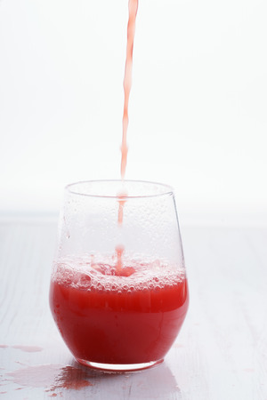 Healthy watermelon drink pouring into a glassの写真素材