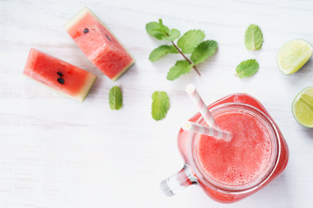 Healthy watermelon drink and fresh watermelon on white backgroundの写真素材
