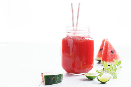 Healthy watermelon drink and fresh watermelon on white backgroundの写真素材