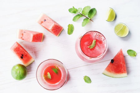 Healthy watermelon drink and fresh watermelon on white backgroundの写真素材