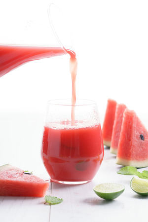 Healthy watermelon drink pouring into a glassの写真素材
