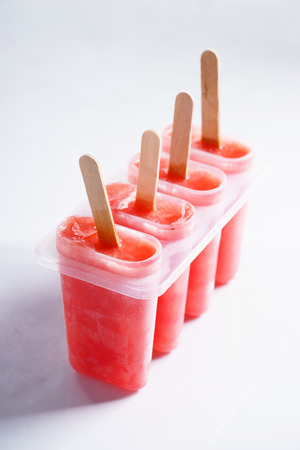 Homemade watermelon popsicles on white marble backgroundの写真素材