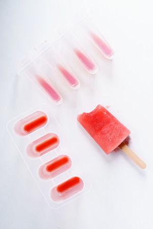 Homemade watermelon popsicles on white marble backgroundの写真素材