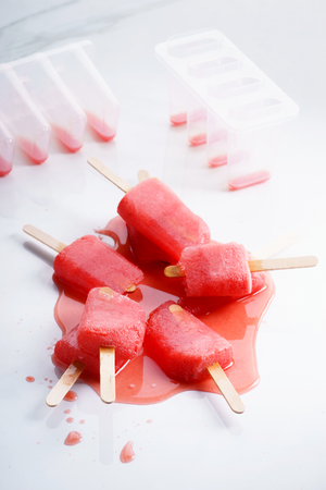 Homemade watermelon popsicles on white marble backgroundの写真素材
