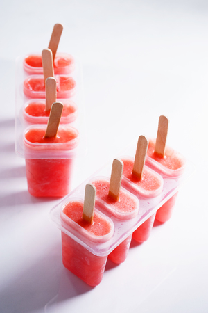Homemade watermelon popsicles on white marble backgroundの写真素材