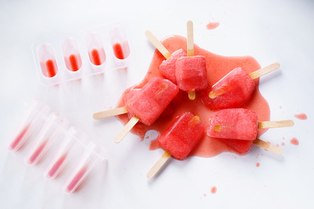 Homemade watermelon popsicles on white marble backgroundの写真素材