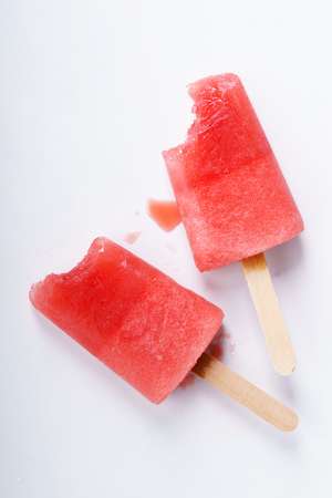 Homemade watermelon popsicles on white marble backgroundの写真素材