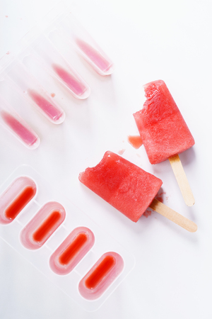 Homemade watermelon popsicles on white marble backgroundの写真素材