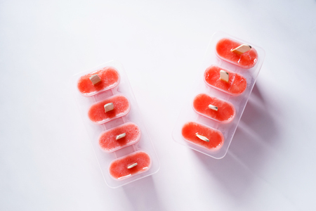 Homemade watermelon popsicles on white marble backgroundの写真素材