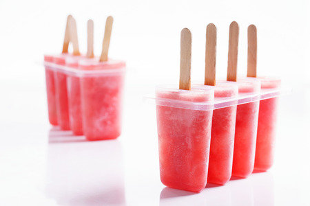 Homemade watermelon popsicles on white marble backgroundの写真素材