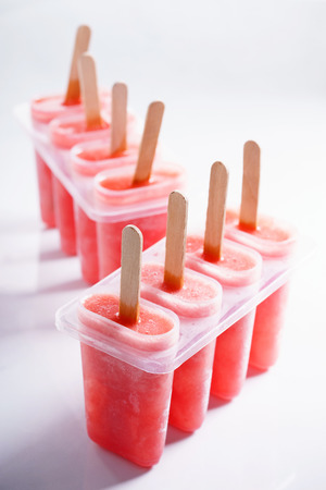 Homemade watermelon popsicles on white marble backgroundの写真素材