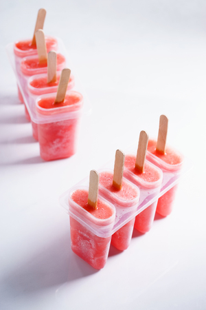 Homemade watermelon popsicles on white marble backgroundの写真素材