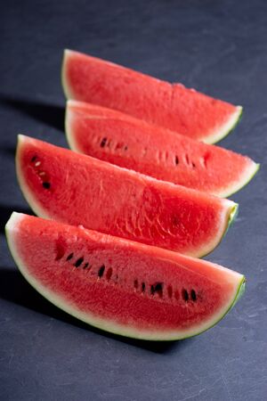 Slices of fresh watermelon on black backgroundの写真素材