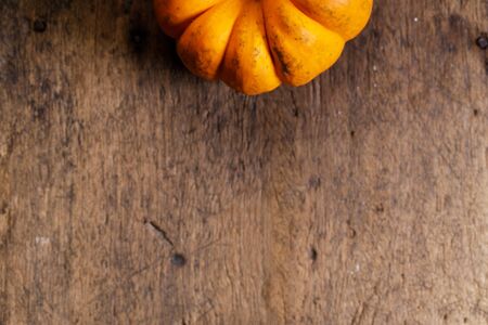 orange pumpkin on rustic wooden backgroundの写真素材