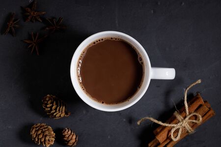 White ceramic cups of hot cocoa with marshmallows on top of rustic black backgroundの写真素材