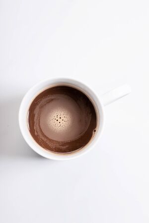 White ceramic cup of hot cocoa on top of white marble background, top viewの写真素材