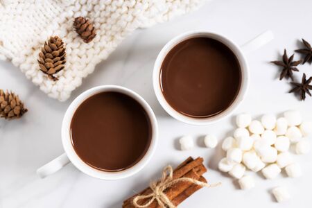 White ceramic cups of hot cocoa on top of white marble background, top viewの写真素材