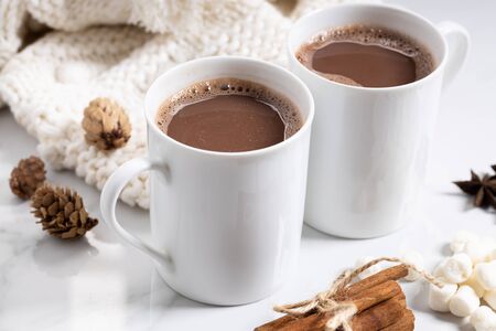 White ceramic cups of hot cocoa on top of white marble backgroundの写真素材