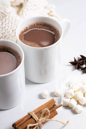 White ceramic cups of hot cocoa on top of white marble backgroundの写真素材