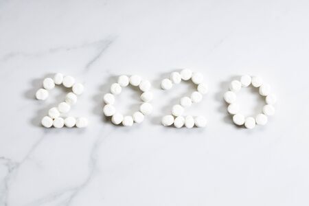 2020-shaped marshmallows stopmotion on white marble background, happy new year conceptの写真素材