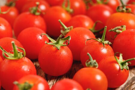 red cherry tomatoes on wooden backgroundの写真素材