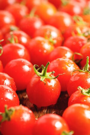 red cherry tomatoes on wooden backgroundの写真素材