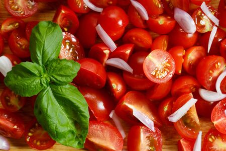 red cherry tomatoes on wooden background on white background on white background and basil leaf on white background on wooden background and basil leaf on wooden backgroundの写真素材