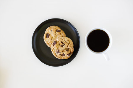 A cup of hot black coffee on white table background.  Work from home concept.