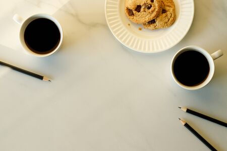 Two cups of coffees on white marble table in morning lightの写真素材
