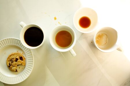 lots of cups of coffees on white marble table, hard work conceptの写真素材