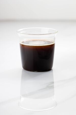 A cup of hot coffee on white marble table background.の写真素材