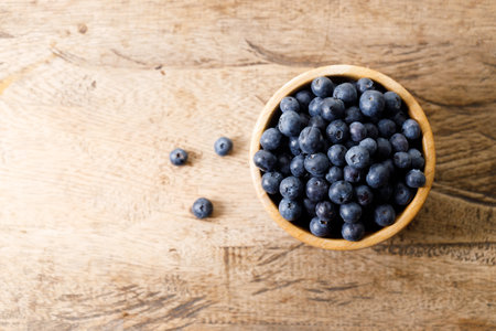 Ripe organic blueberries on wooden table background. Selective focus.の写真素材