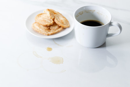 Cup of black coffee, palmier butterfly pastry on white marble background. Working concept.  Selective focus.の写真素材