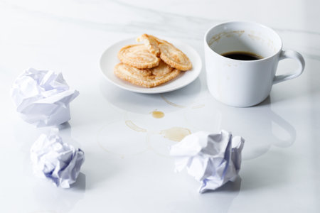 Cup of black coffee, palmier butterfly pastry on white marble background. Working concept.  Selective focus.の写真素材