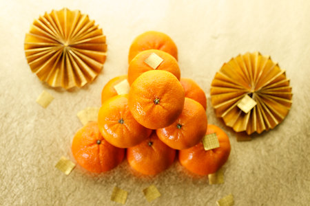 Tangerine oranges on golden background for celebration Lunar New Year or Chinese New Yearの写真素材